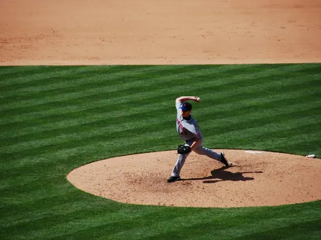 In this image there is a baseball player who is standing on the ground and throwing the ball. In...