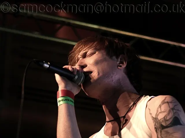 As we can see in the image there is a man holding mic and singing a song.