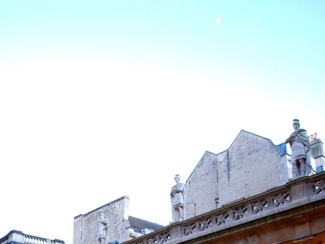 In this image I can see the water. In the background I can see the building with pillars. I can see...