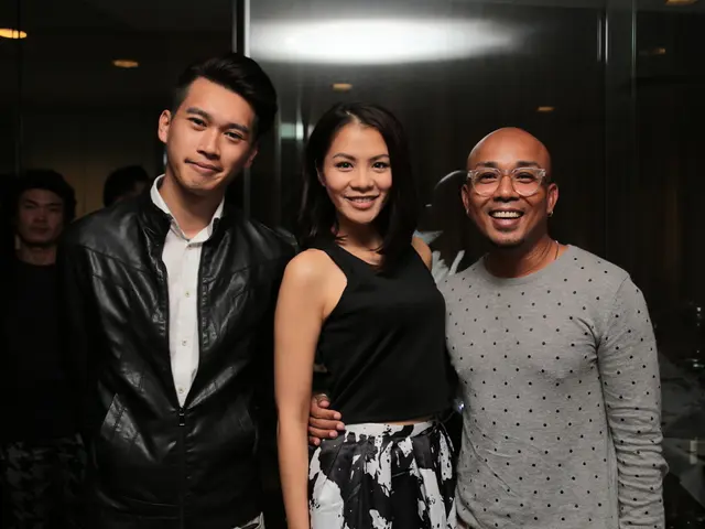 Front these three people are giving stills and smiling. Background there are two people.