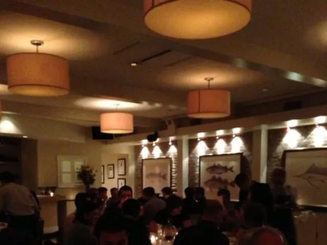 At the bottom of the picture, we see a table on which water bottles, glasses, plate containing...