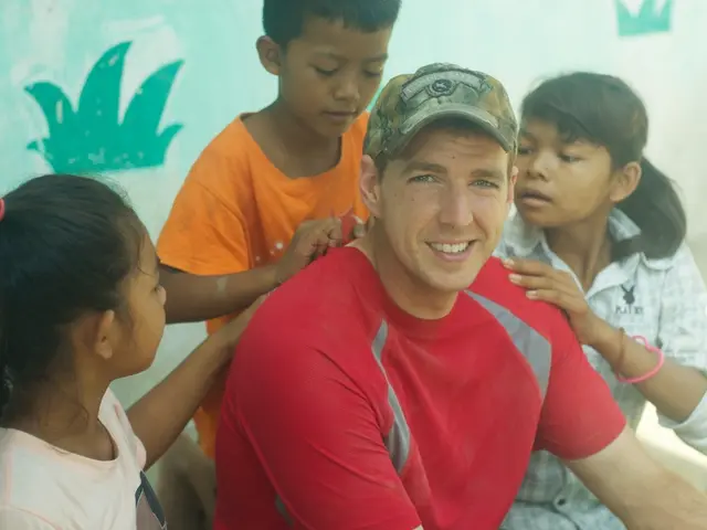 In this picture we see a man sitting alone with 3 kids.