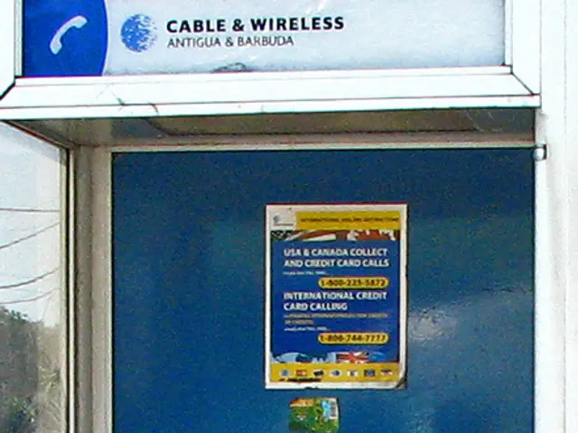 In this image we can see a telephone in the booth.