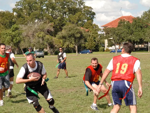 In this image there are people playing american football. In the background of the image there are...