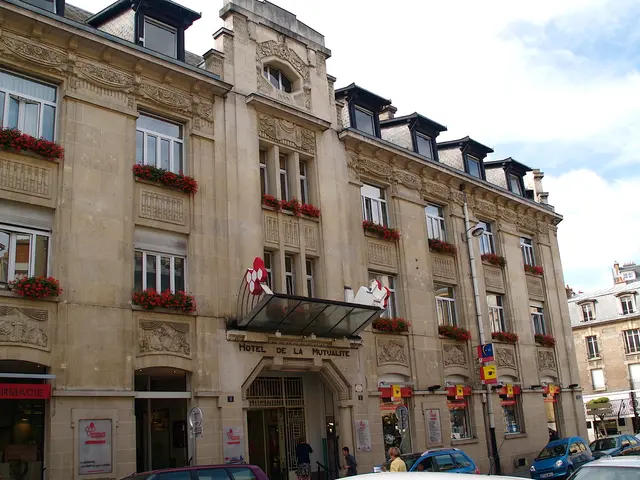 As we can see in the image there are buildings, plants, flowers, windows, few people here and...