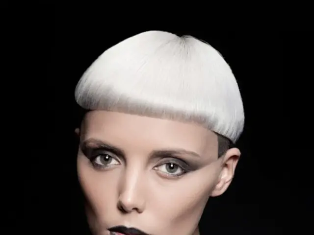 In this image I see a woman who is wearing white and light brown color dress and I see that it is...