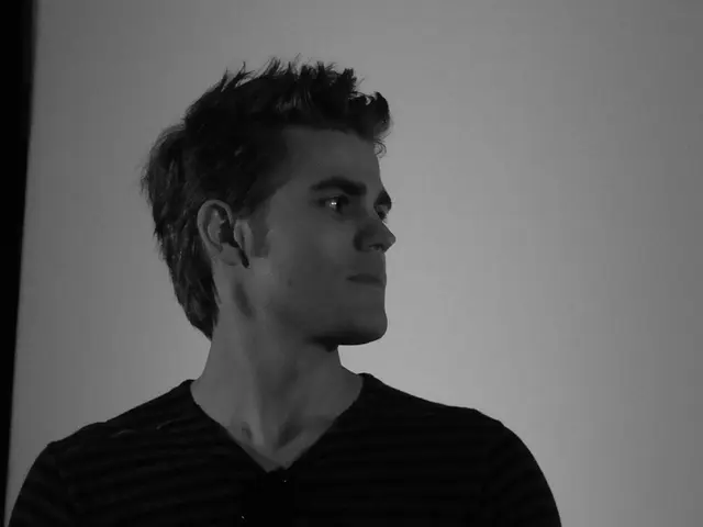 In this image I can see the person with the dress and this is a black and white image.