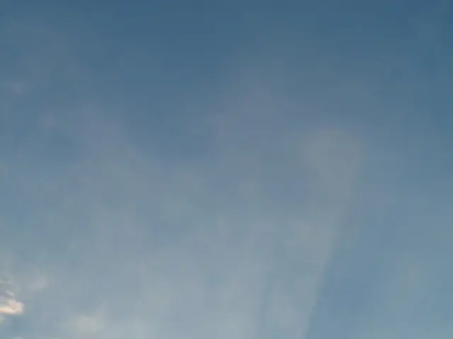 This picture is clicked outside the city. In the foreground we can see the trees, cables in the...