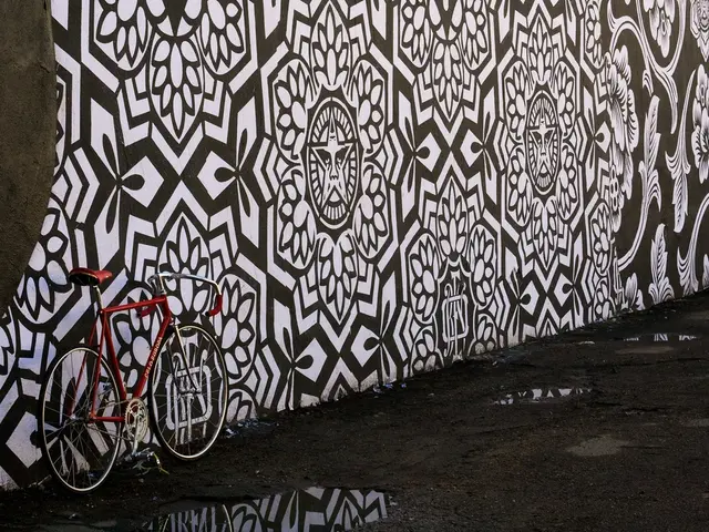 This image is taken outdoors. At the bottom of the image there is a road. In the middle of the...