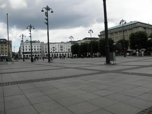 In the middle there are very big buildings and street lamps. At the top it is a cloudy sky.