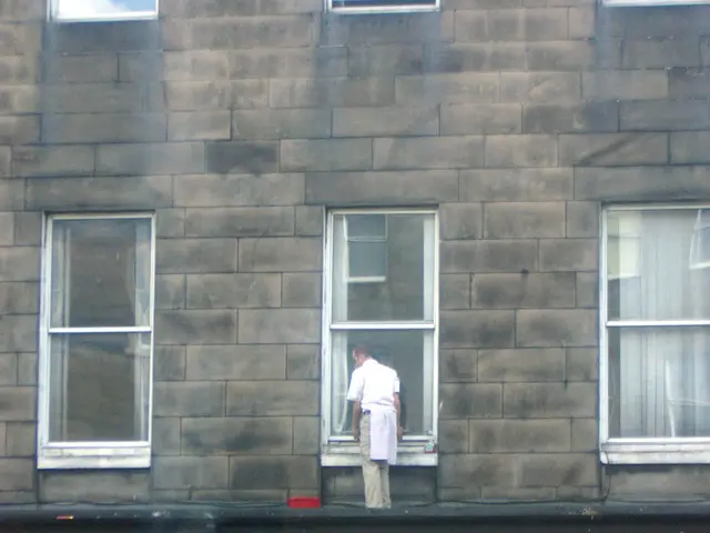 In this picture there is a Pizza hut shop in the front. On the top there is a man standing and...