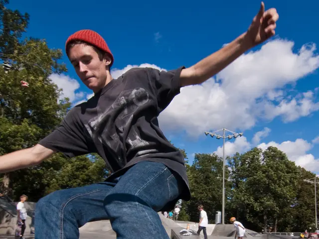 This image is clicked outside. There are trees in the middle. There are so many persons skating in...