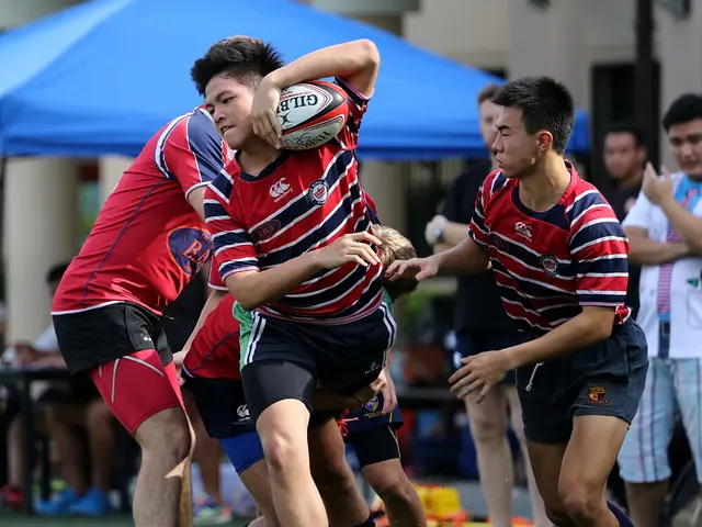 This picture is taken in the ground, There are some people playing a game, In the middle there is a...