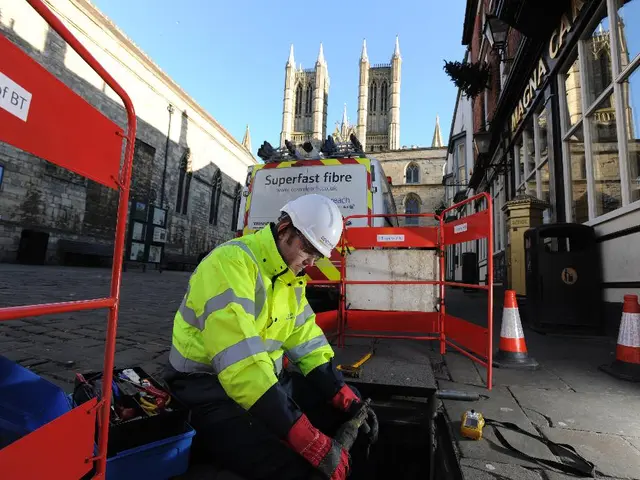 In this image I see a man who is wearing uniform and I see few boards and traffic cones over here...