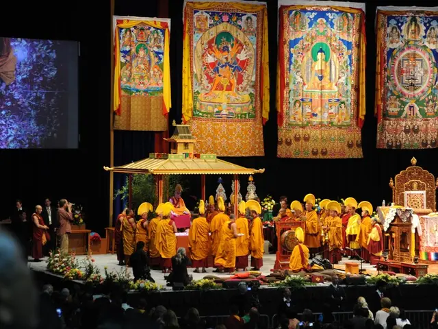 In this image we can see the screen. And we can see people on the stage. And we can see the shed....