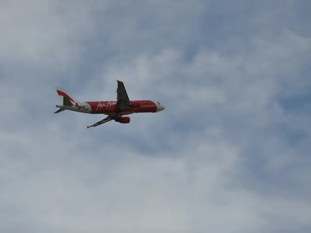 In this image there is an airplane flying in the sky and the sky is cloudy.
