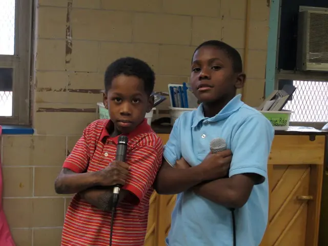 In the image we can see there are two kids who are standing and holding mic in their hand.