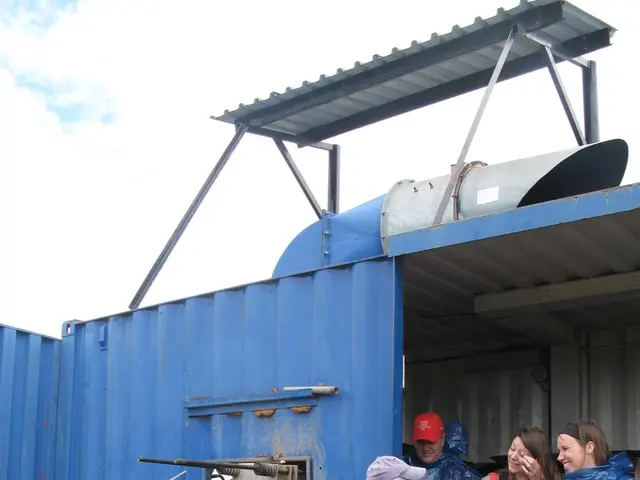 This image consists of five persons wearing jackets and standing. At the bottom, there is a ground....