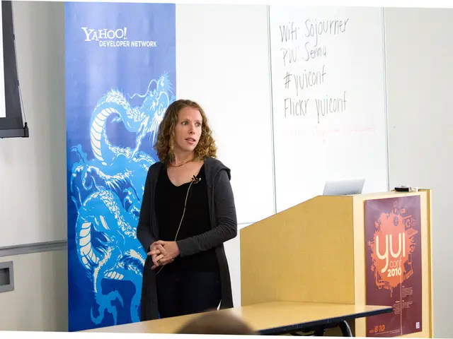 This image is clicked in meeting room. There is a woman, standing near the podium. And she is...