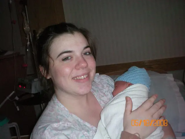 The woman at the bottom of the picture wearing a white dress is holding the baby in her hands and...