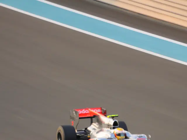 In the middle I can see a person is driving a sports car on the road. This image is taken may be on...