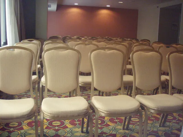 In a hall there are a lot of chairs arranged in an order,in the left side there is a window and in...