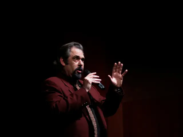 This is an image clicked in the dark. In the middle of the I can see a man wearing a suit and...