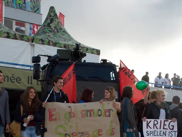 The picture is taken on the streets of a city. In the foreground on the road there is a balloon. In...