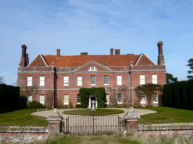 In this image there is a building and in front of it there is a gate. At sidewalls there is a...