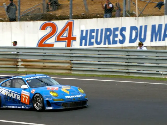 In the foreground of this picture, we see a sports car moving on road. In the background, we see...