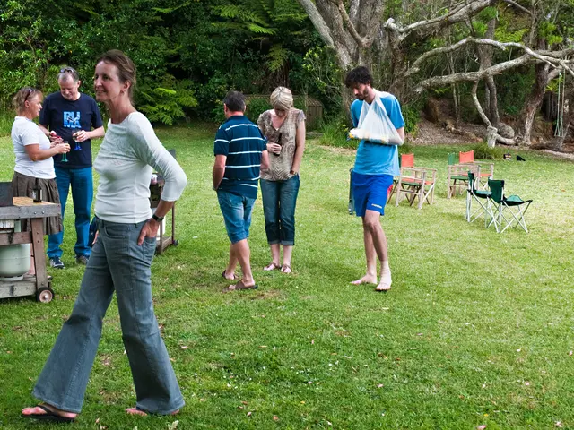 In this image, group of people are standing, few are walking, few are smiling. We can see bottle ,...