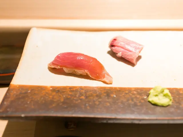 In this image there are some food items served on plate and kept on a table.