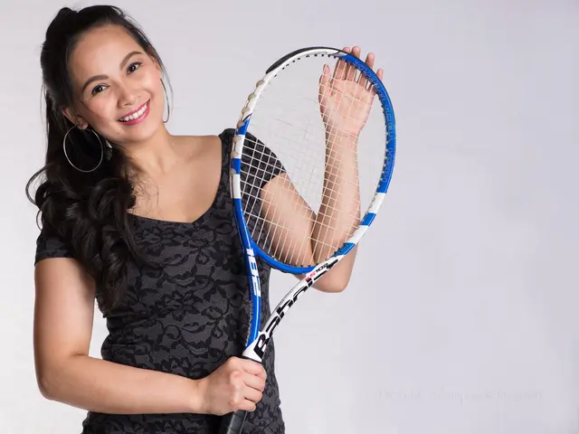 As we can see in the image there is a woman holding shuttle bat in her hand and wearing black color...