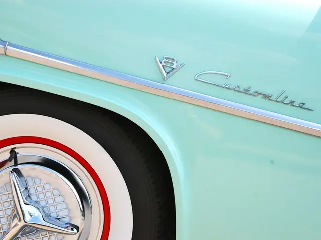 In this image in the foreground there is one vehicle and tire, and on the vehicle there is some...