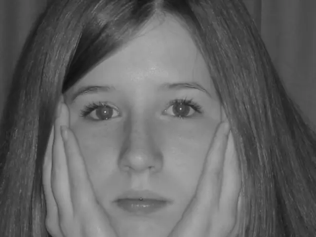 In this image I can see a woman. She is wearing watch. The image is in black and white.