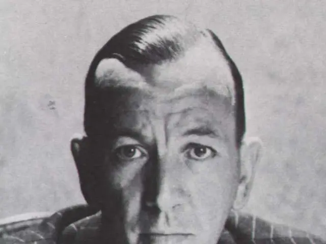 It looks like a black and white picture. We can see a man in the blazer.