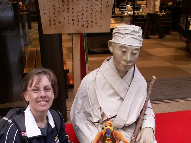 In this image we can see a person holding a bottle beside the statue and there is a toy and a stick...