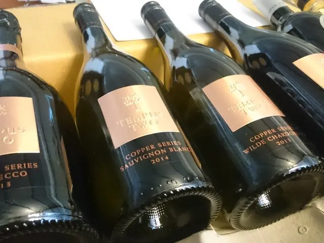 In this image I can see many wine bottles and a paper.