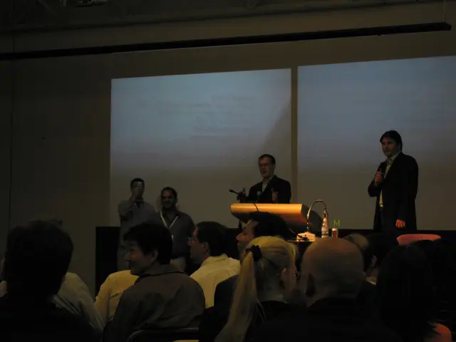 This picture is taken in the dark where we can see these people in the foreground are sitting on...