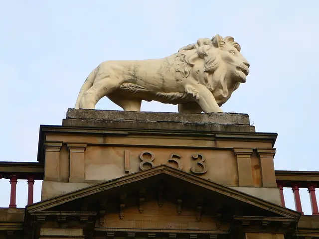 In this picture there is a statue of a lion on a building and there is 1853 written below it.