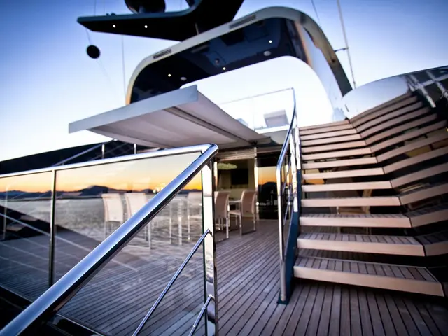 In this image there is a glass building. On the right side there are steps. On the left side there...