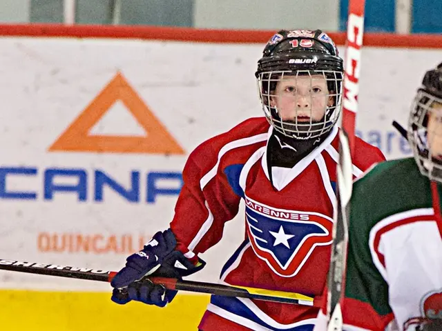 In the picture we can see two people are skating on the ice floor holding sticks and wearing a...