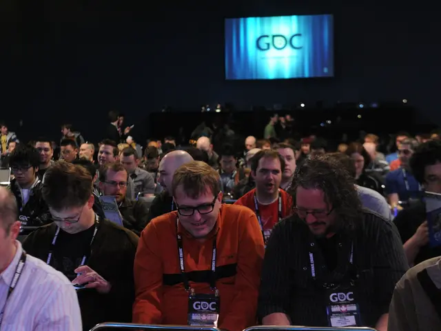 Here we can see crowd and a screen. There is a dark background.