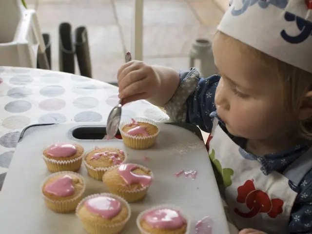 Here in this picture we can see a child present over a place, holding a spoon in her hand over...