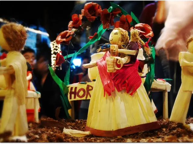 In the image there are few idols on the floor and over the background there are few humans visible.