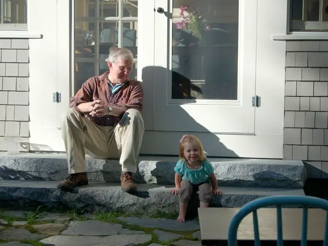 In this image, I can see an old man and a baby girl sitting on the stairs. This is a door with a...