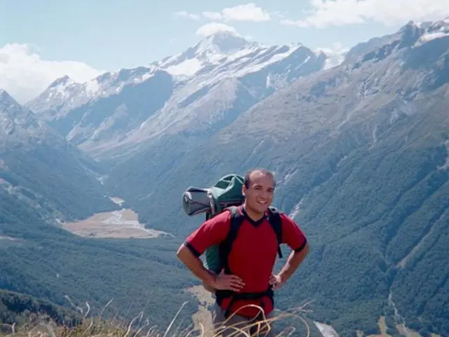 In the image I can see a person who is wearing the back pack and standing and behind there are...