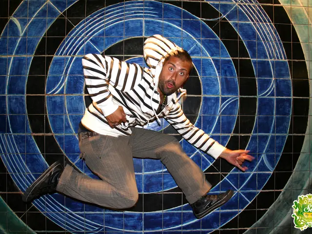 In this image we can see one man dancing, one logo with text at the right side corner of the image...