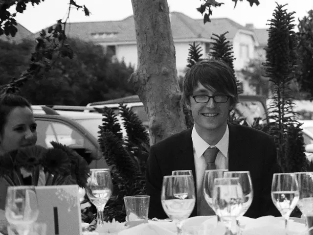 Here a couple is sitting, these are glasses and trees, this is house.