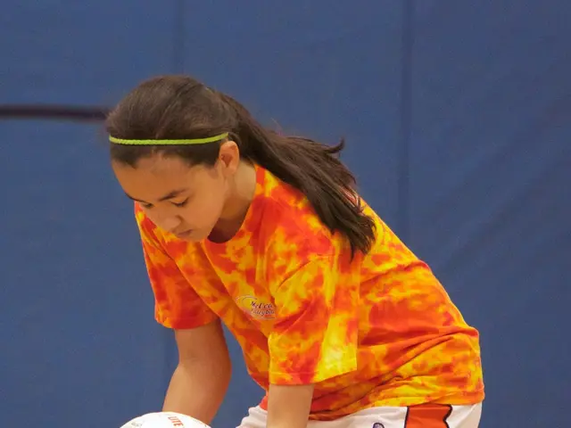 This picture describes about a standing woman and she is holding a ball in her hands.